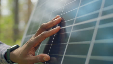 Unrecognizable-Man-Touching-Solar-Panel